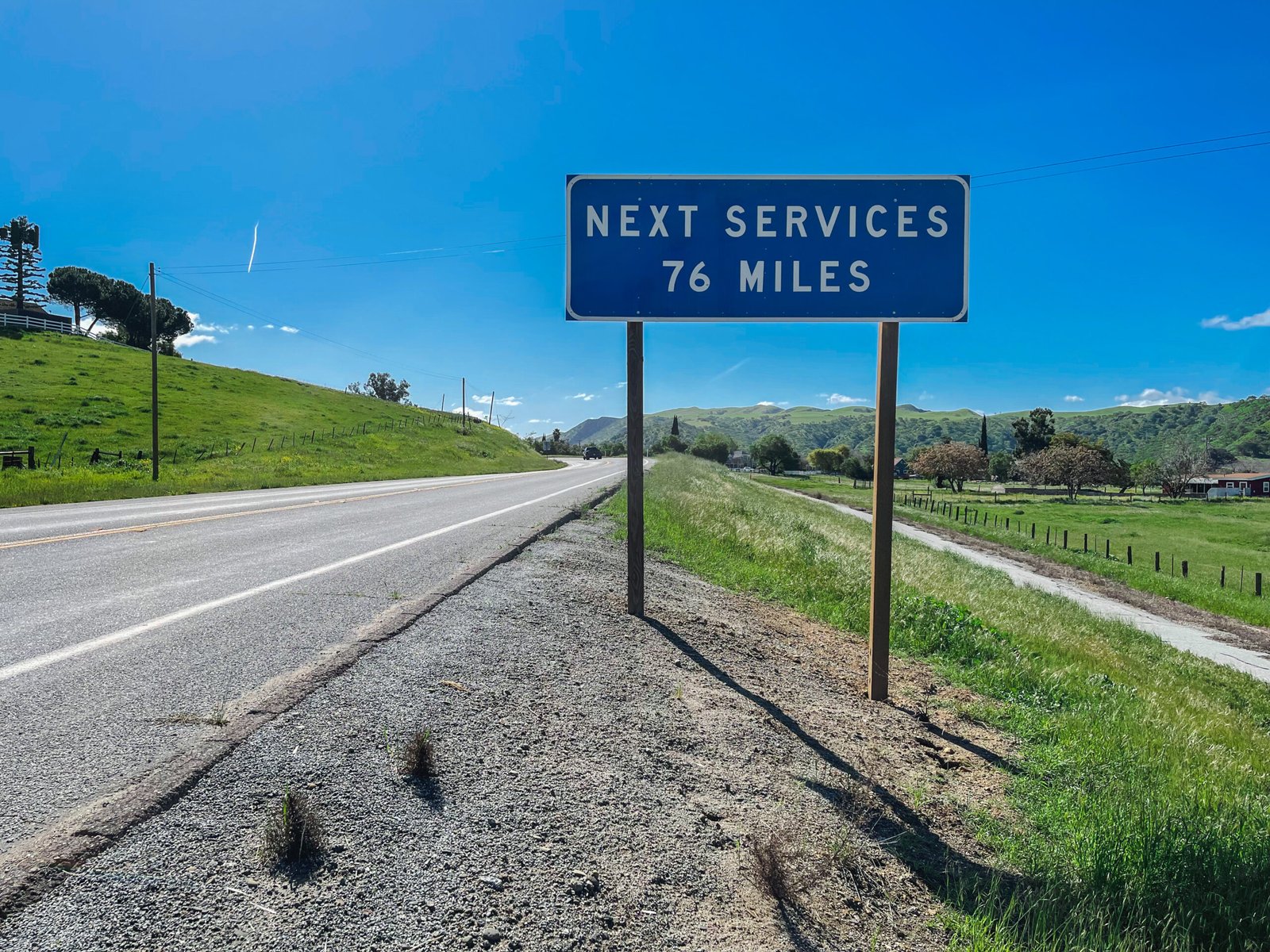 road sign next services 76 miles